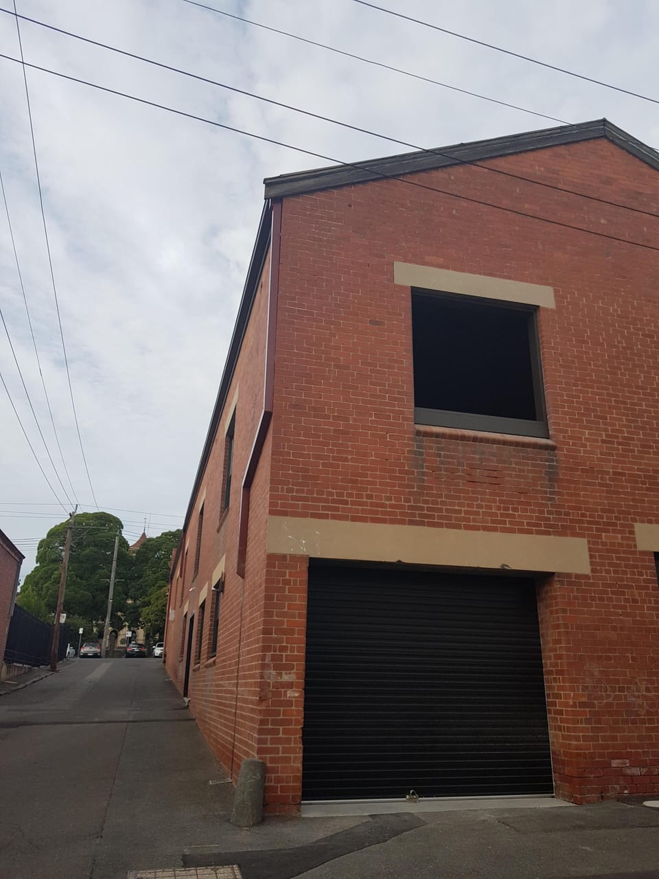 Rear garage access with overhead balconies 