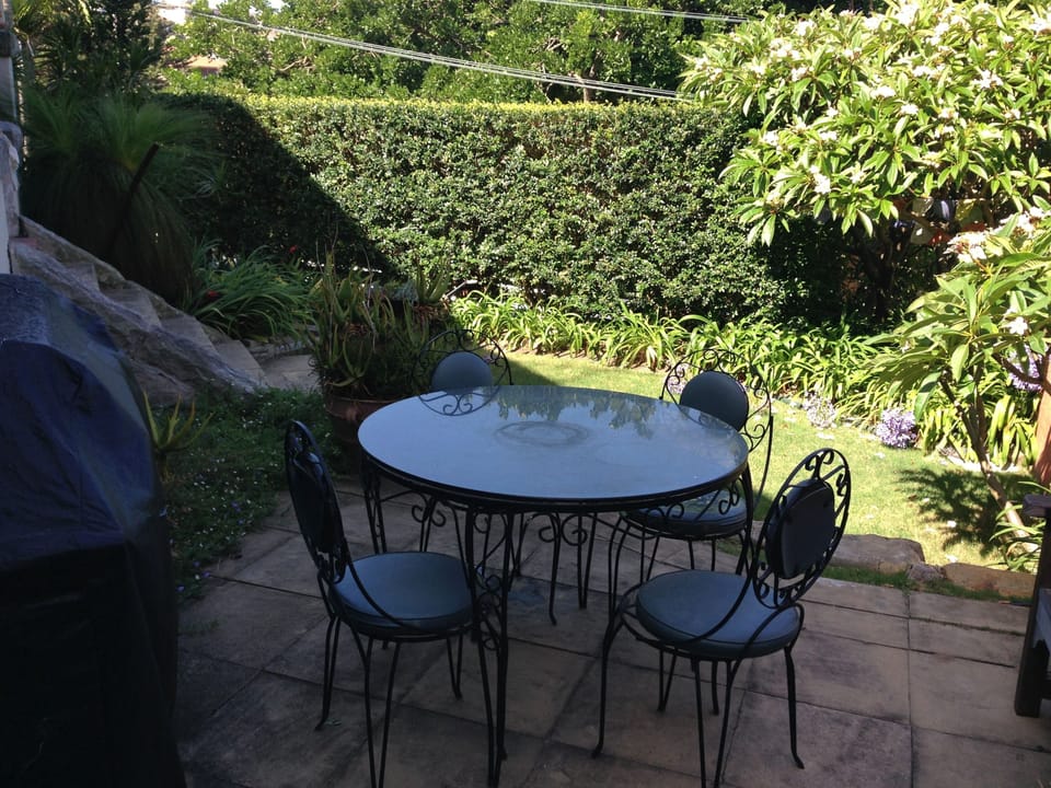 garden dining setting with barbecue