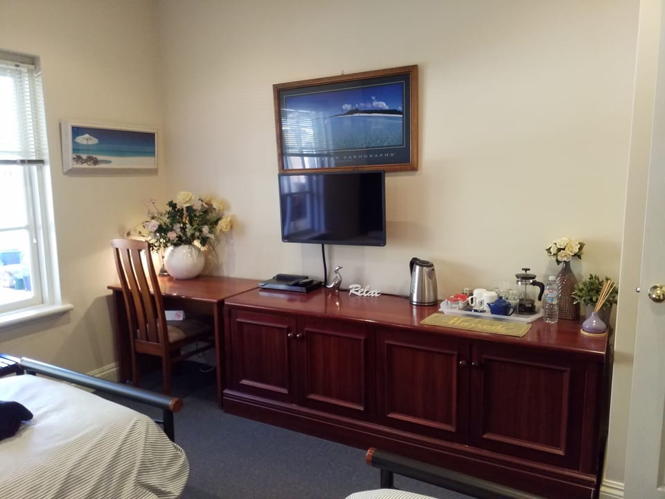 Study desk, flat screen TV, DVD player and refreshments at hand.