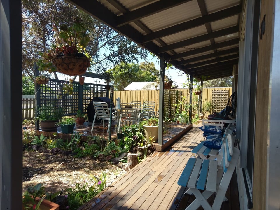 On the deck at front of house.