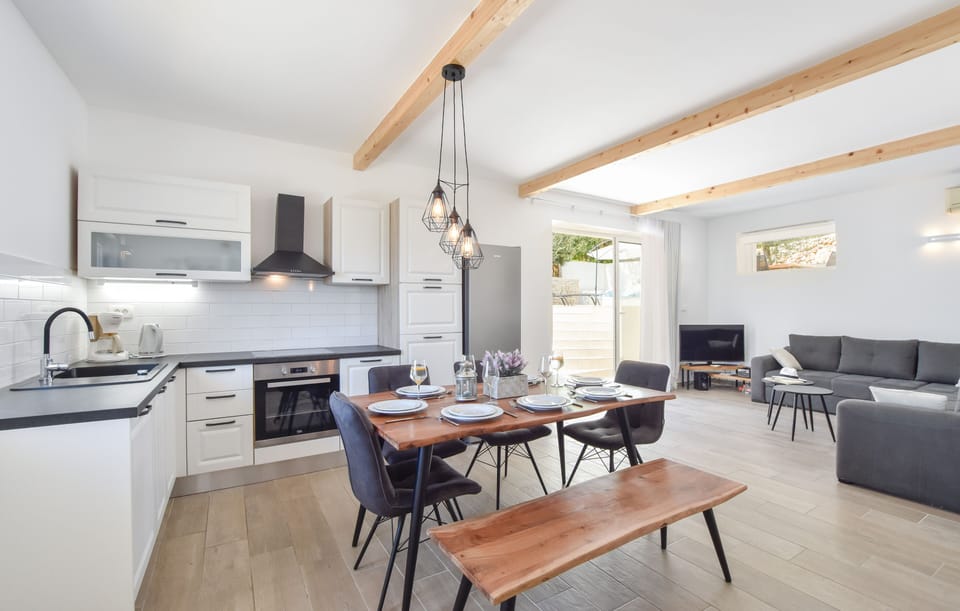 Fully equipped kitchen, dining table, sofa TV, Air conditioner, exit to the pool
