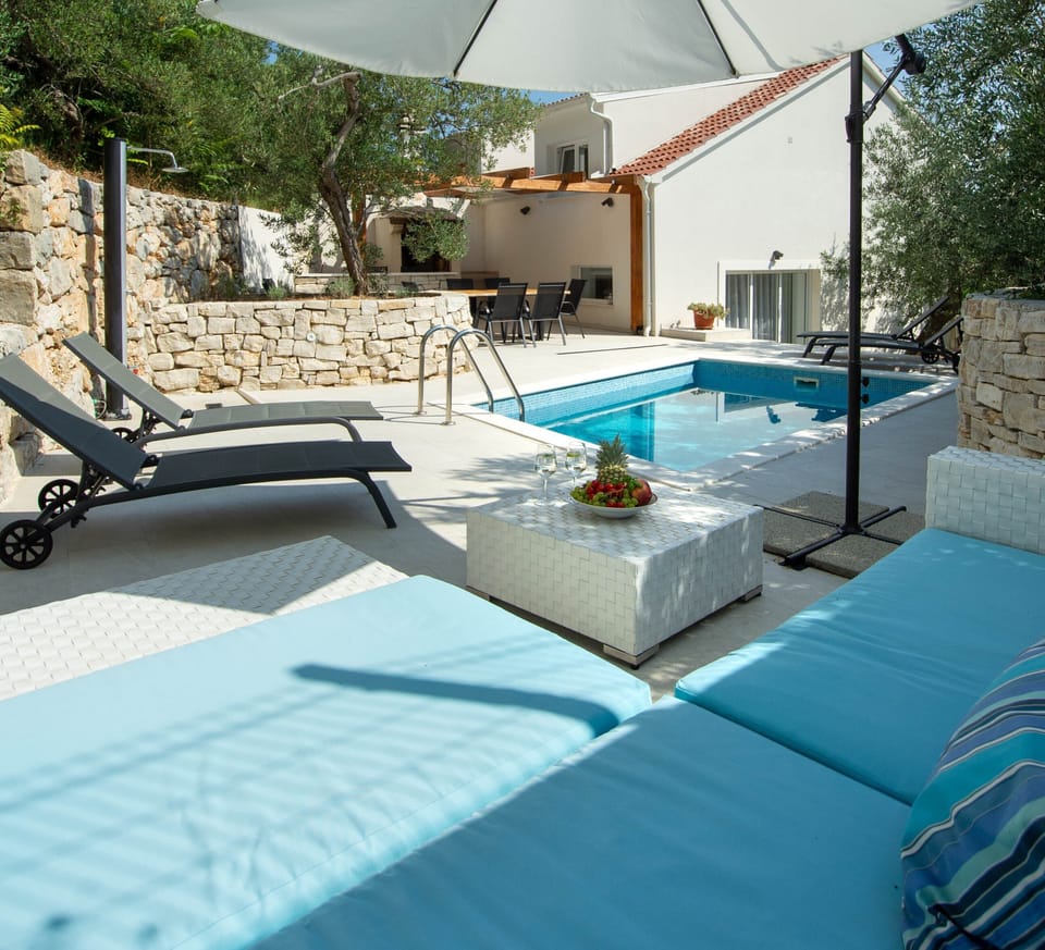 Outdoor sofa with sun umbrella. Relaxing zona.
