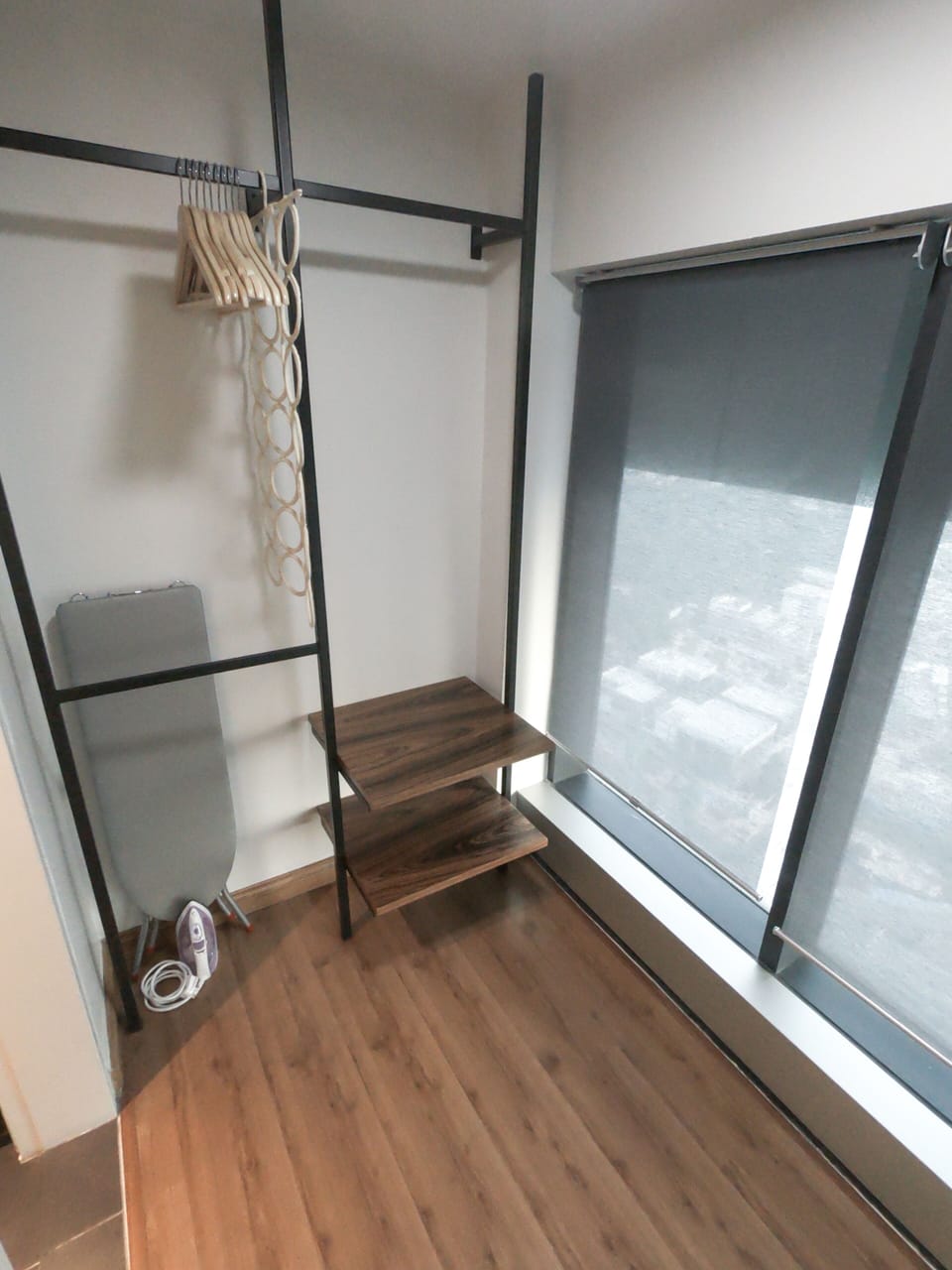 Closet space, hangers, ironing board, iron
