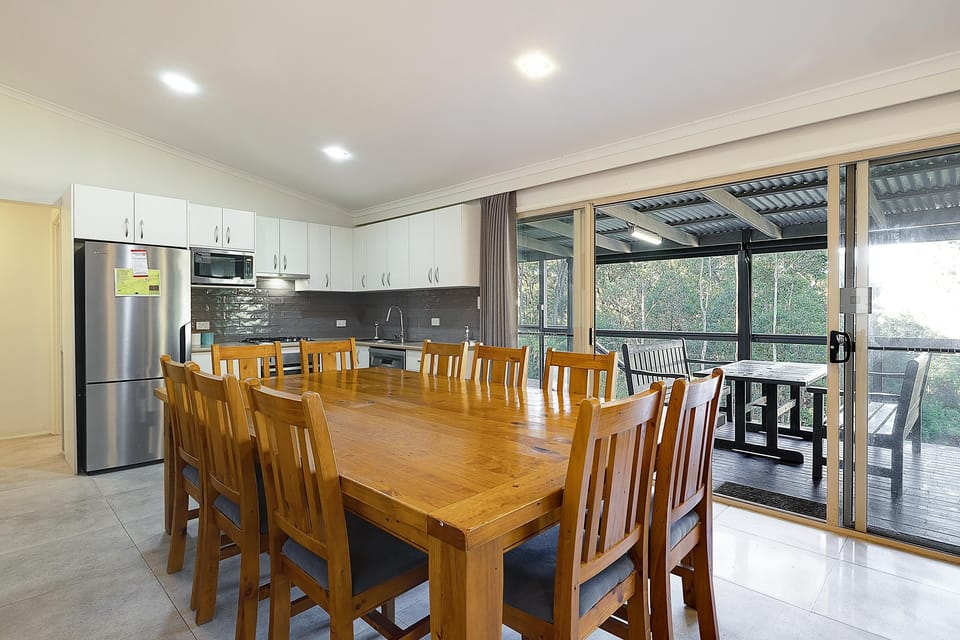 Large 10 seater dining table with room for additional chairs inside