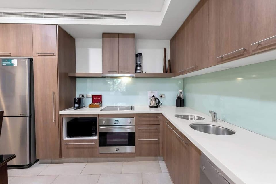 The kitchen is fully-equipped for your holiday catering, with an wight-seater timber table accommodating all guests for a meal at home.