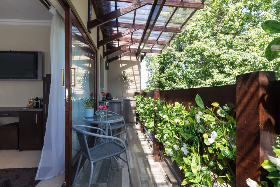 Relax in an open & covered balcony nestled in trees