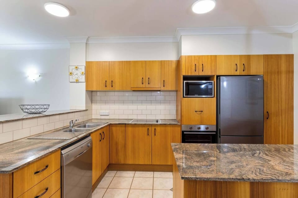 Discover the sleek and functional kitchen, complete with state-of-the-art appliances, a spacious countertop, and convenient storage solutions. 
