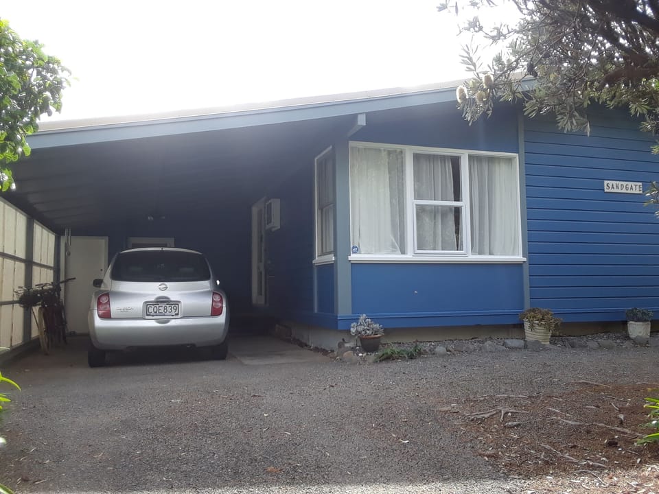 Car port at the top of the driveway. Front door at end of carport on the righ