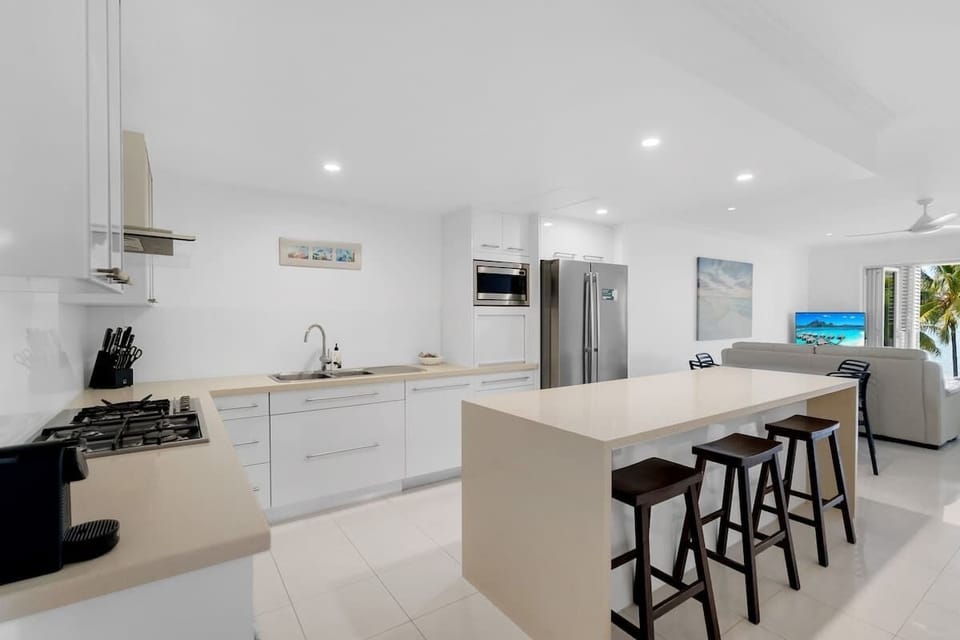 The kitchen centres around an island with bench seating to converse with the cook.