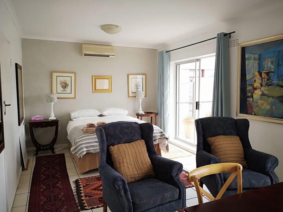 Bedroom 2 with en suite bathroom upper road level with sliding  door onto patio.