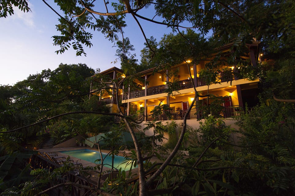 This apart. is situated on the right side of the photo, lower level above pool.