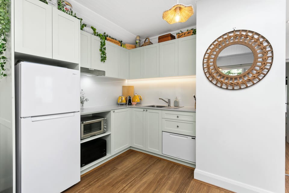 Kitchen with toaster, kettle, nespresso coffee maker, bench top oven, hot plate
