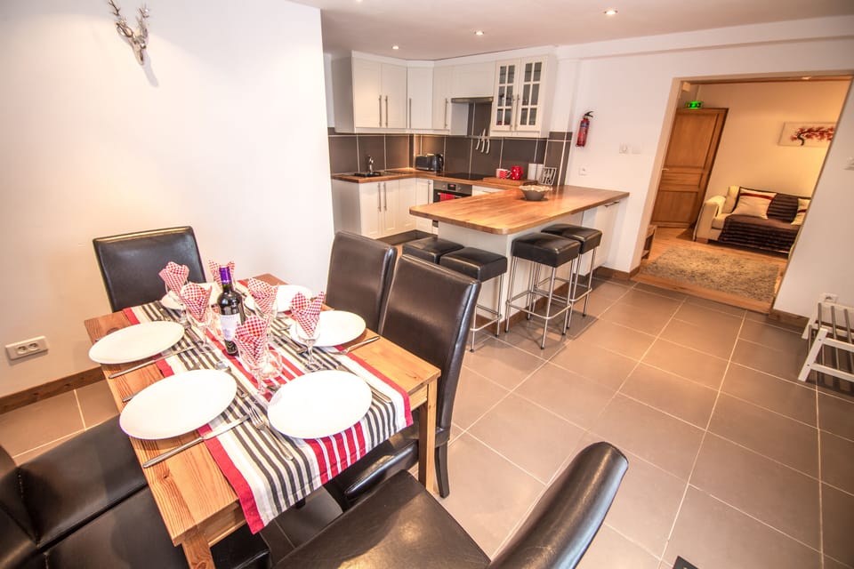 Dining table, breakfast bar and kitchen in the apartment