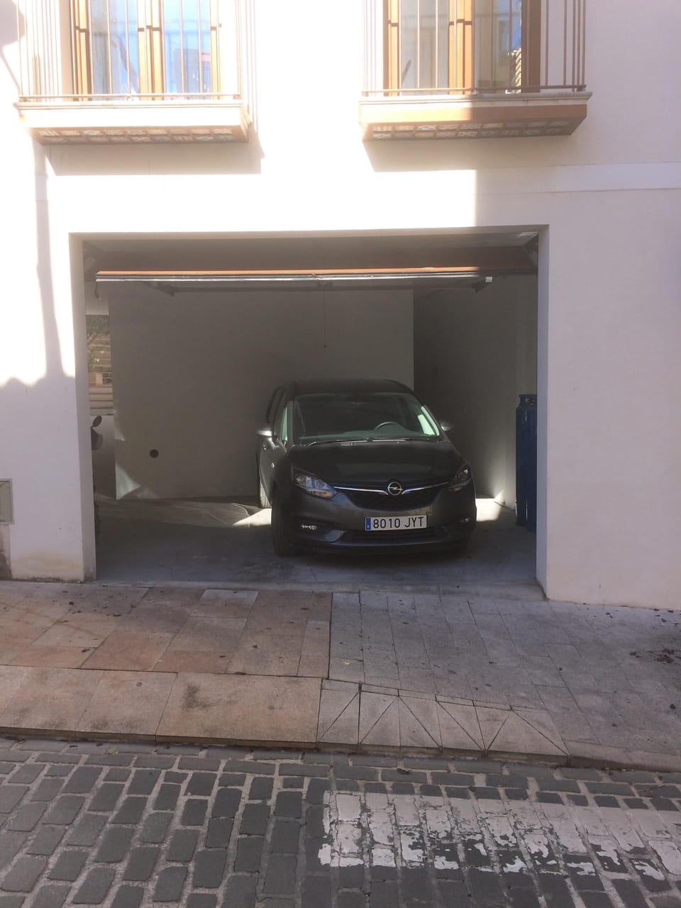 Double garage onto the Ronda Sur. Walkway through to garden and back of house.