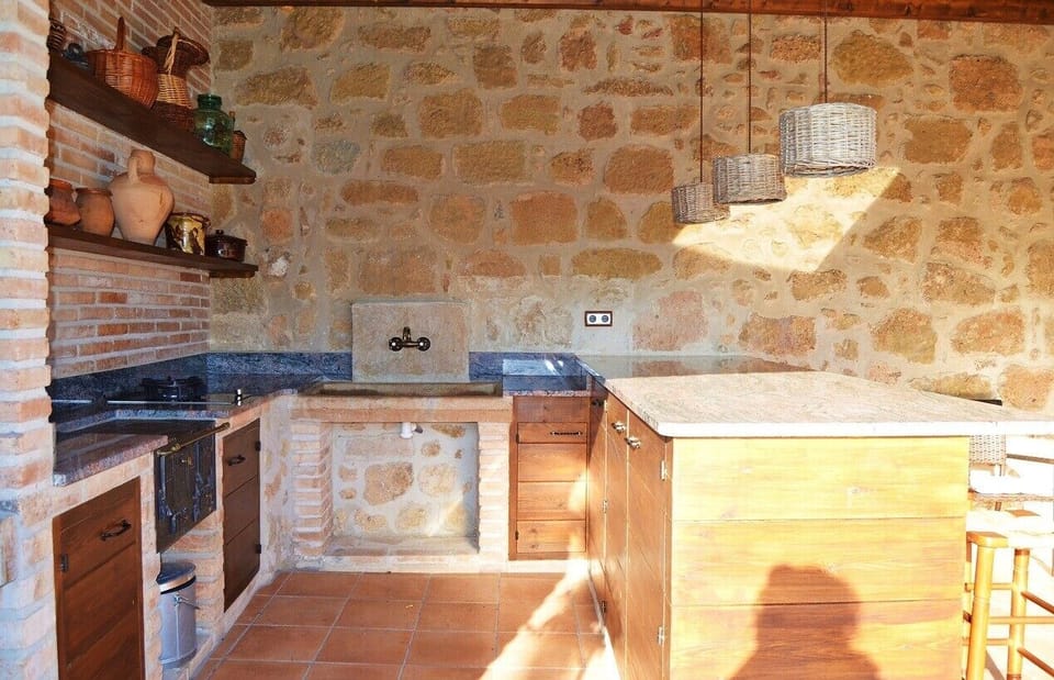 The outdoor kitchen with BBQ and utensils