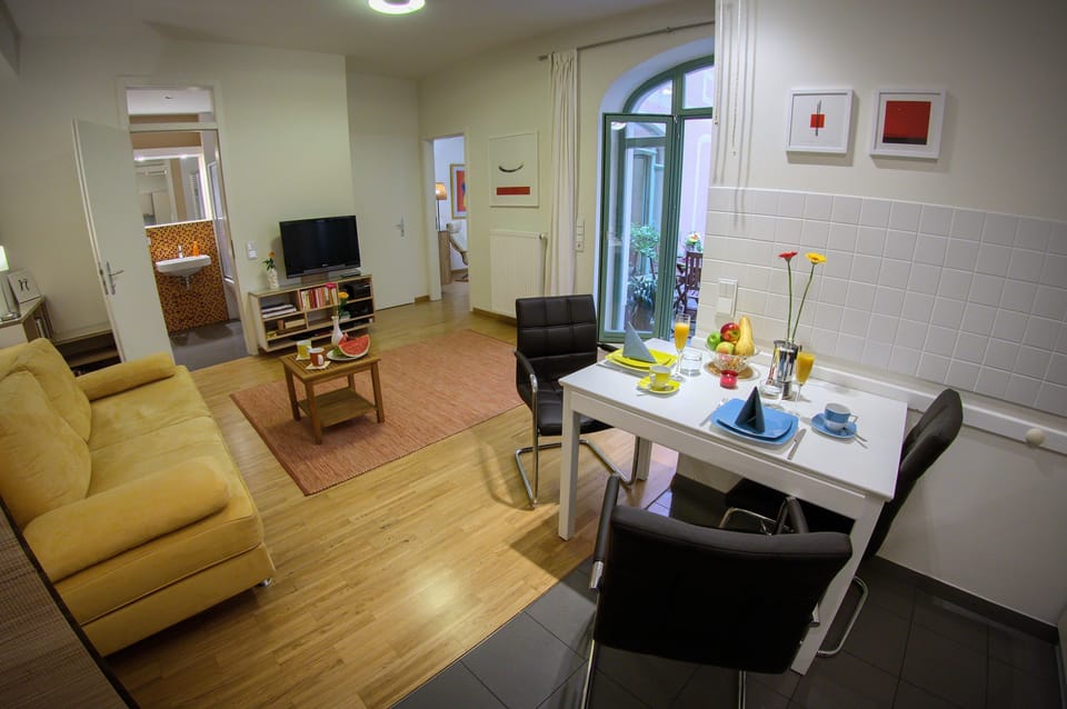 Living room with sofa bed, dining table, rear access to bathroom, chamber