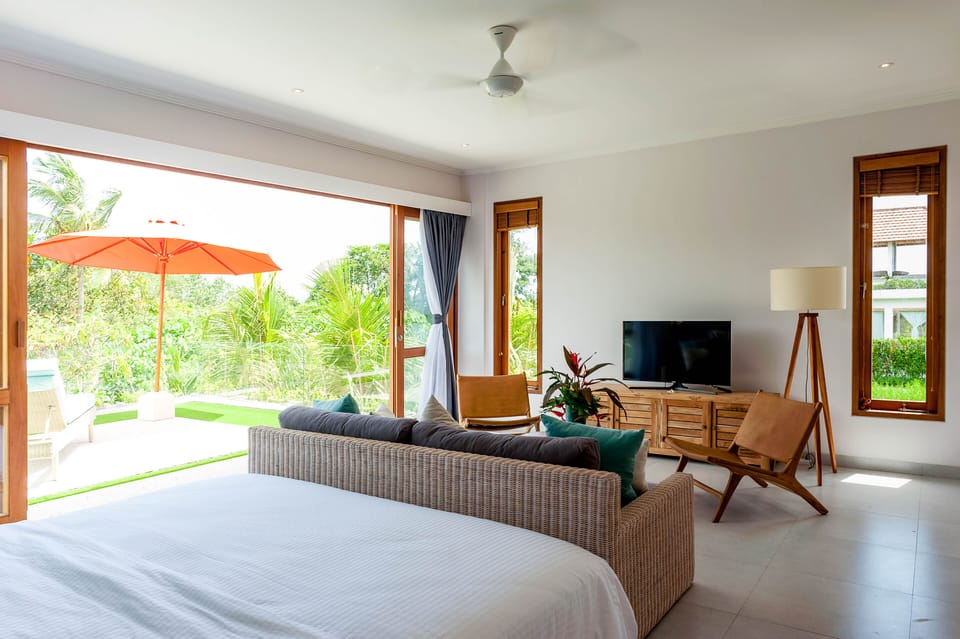Upper floor room with smart TV, sofa area & big terrace overlooking the garde