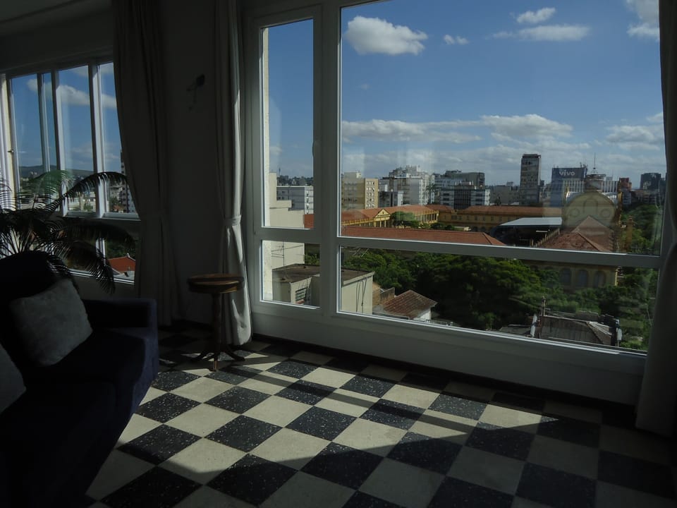 Sofa on the left, giant window looking at the military school