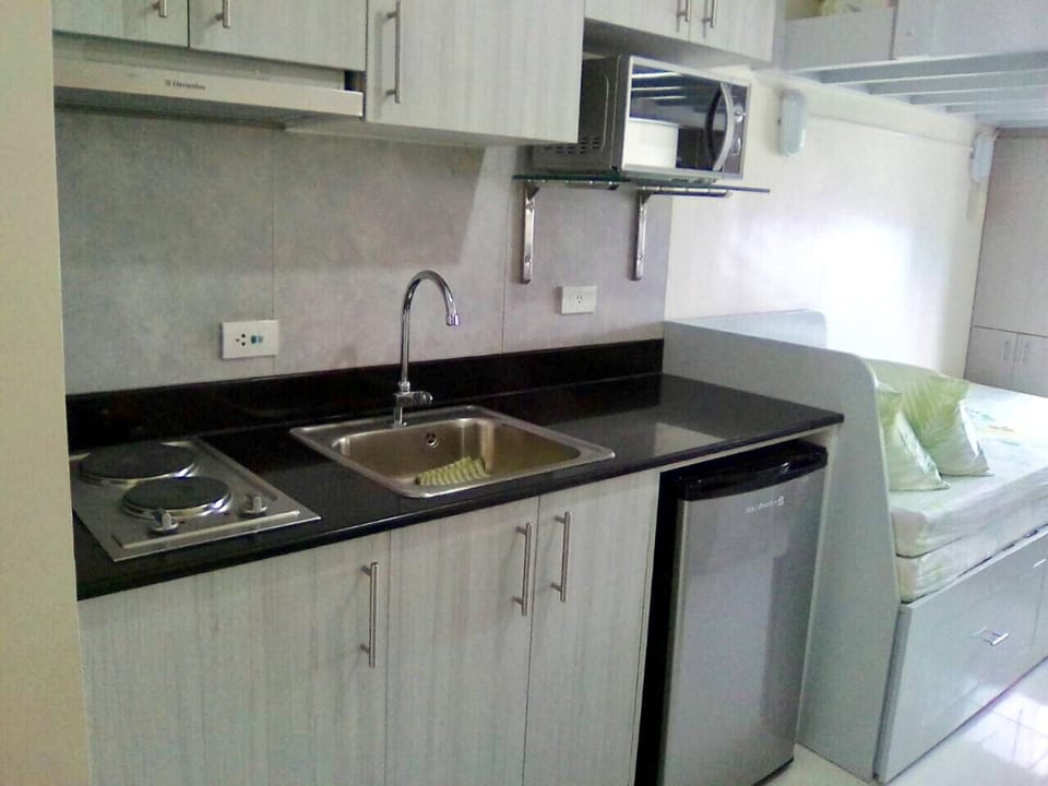 Kitchen with fridge and microwave