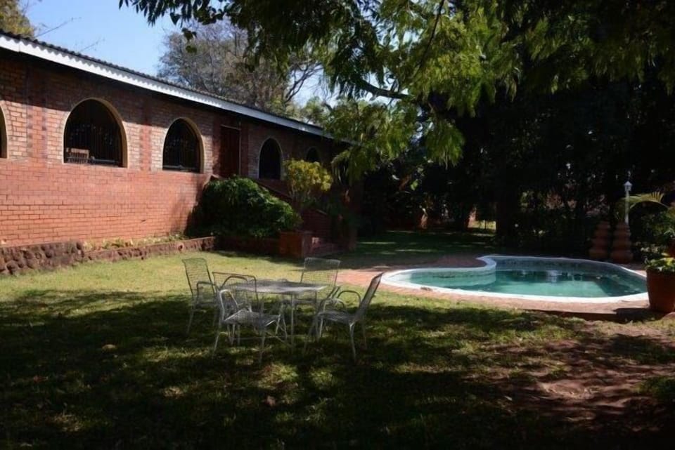 outside pool area with 4 seater patio furniture 