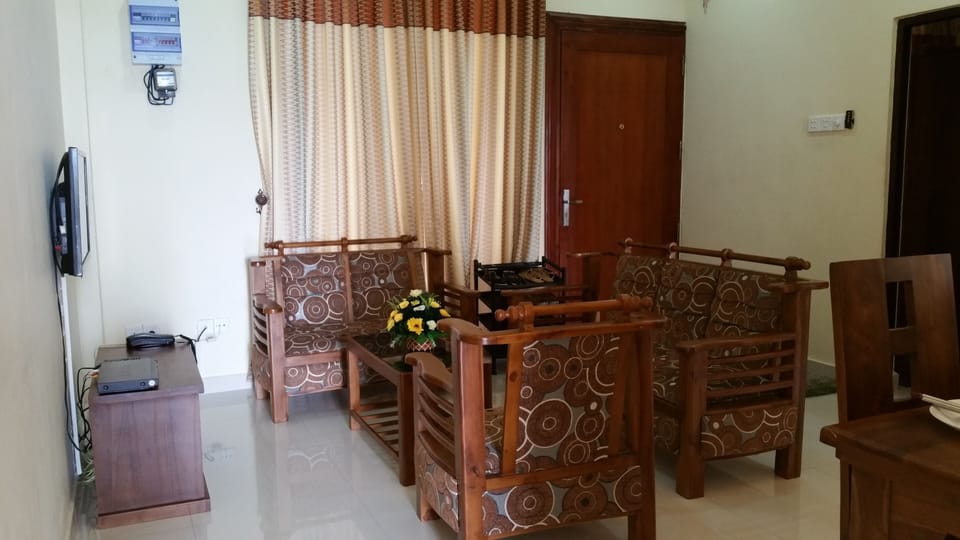 Living Room (Natural Team Timber Sofa and Flat TV Screen)