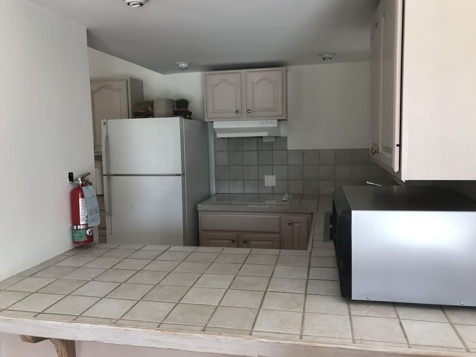 Villa 437 Kitchen area with stove top & microwave