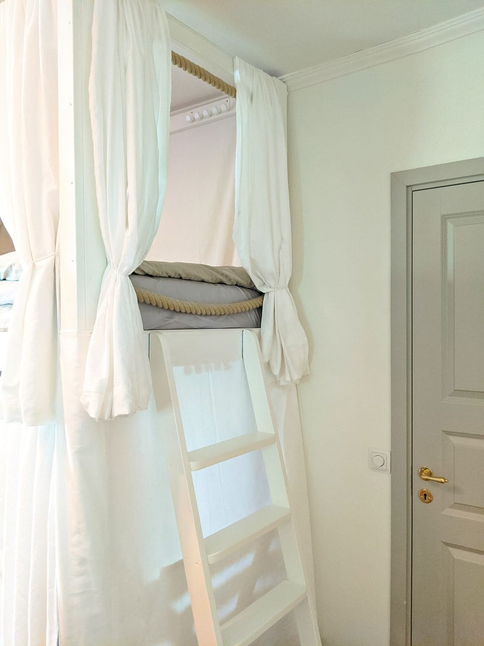 Enter the bunk bed using the ladder and rope handles.