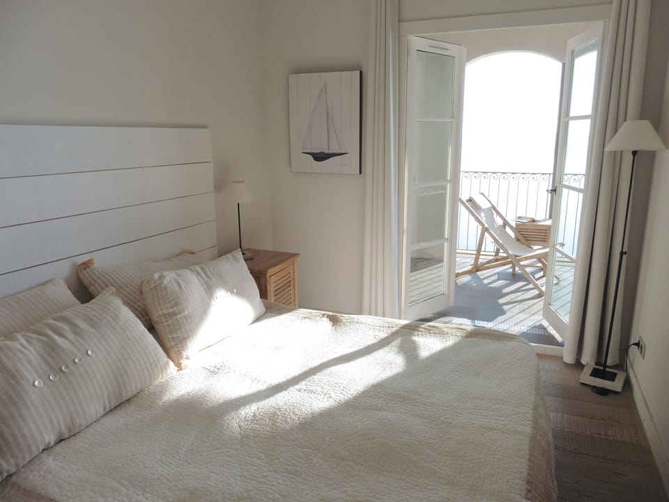 Bedroom 1, extra large double bed and doors to terrace with sea views