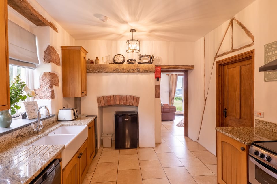 Kitchen with separate fridge, leading into the living room.