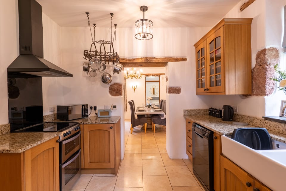 Kitchen with an oven and microwave, leading into the dining area.