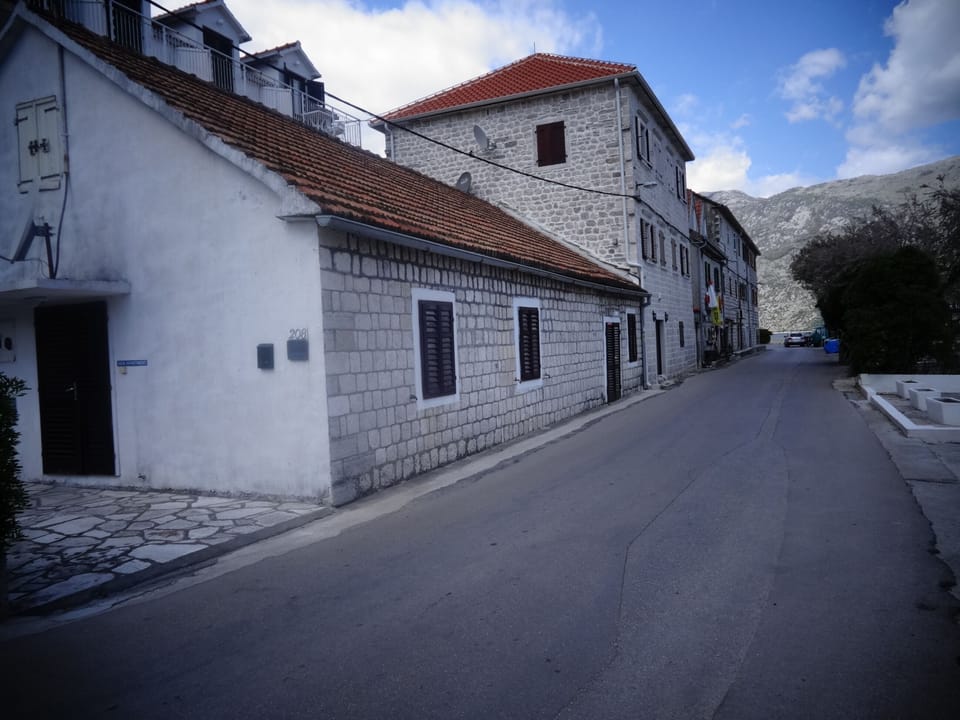 Apartment is placed aside in smaller stone house. Across is waterfront terrace