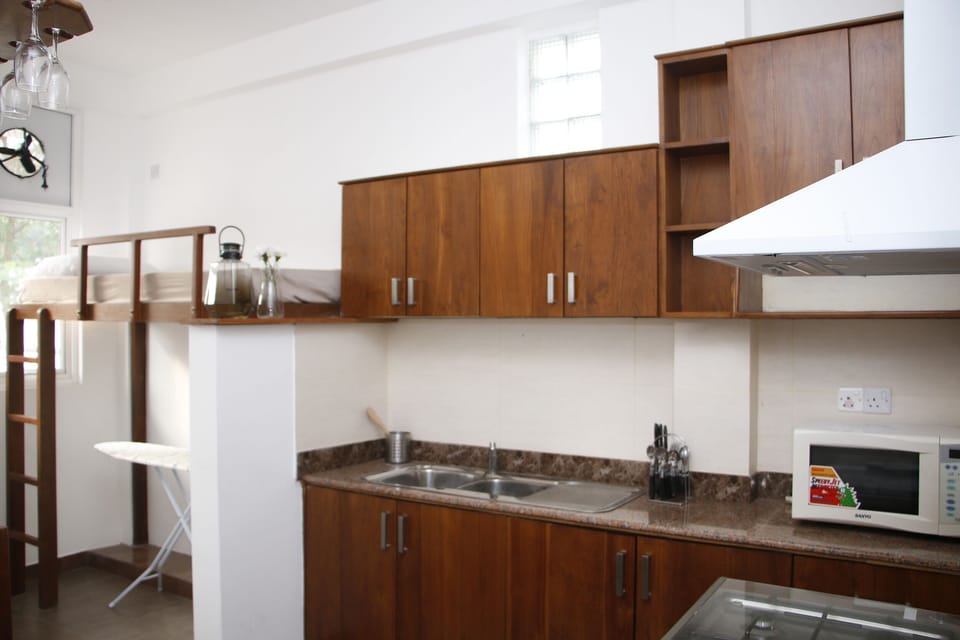 natural timber pantry with Granite tops. Adjoining maids romm with bunk bed