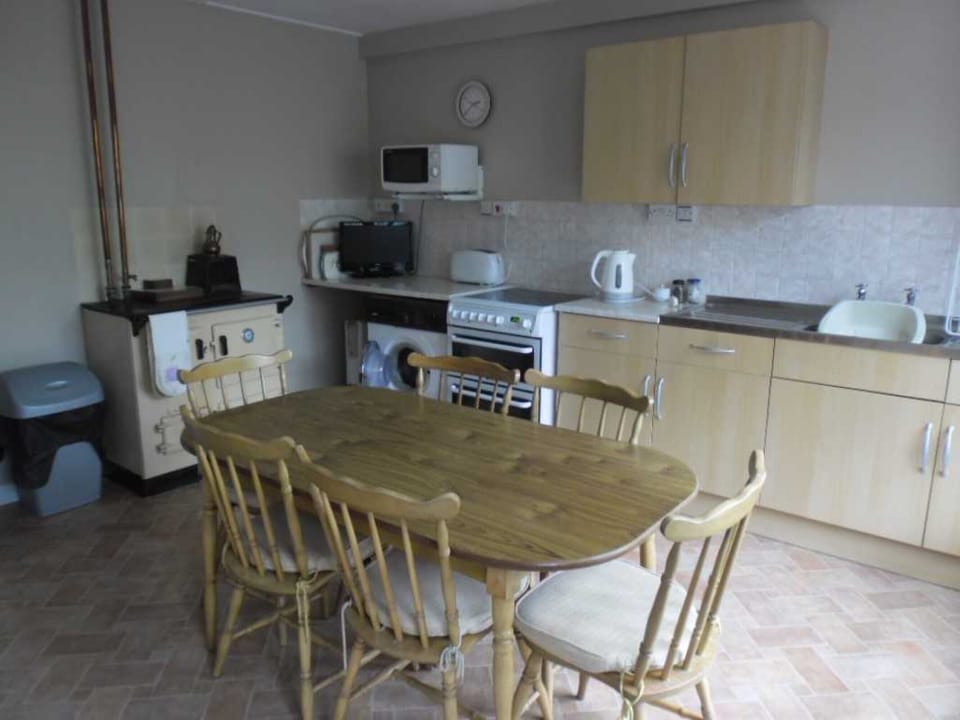 Kitchen with washing machine, microwave, electric cooker and small T.V.