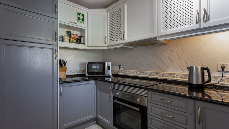Kitchen with microwave, hob, fridge and freezer