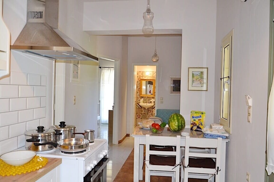 Kefalonia 2 bedroom apartment: kitchen with sink, stove, oven, dining table