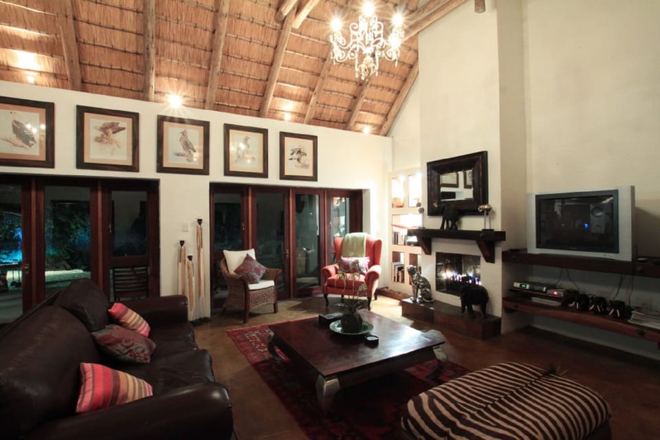 Lounge area with fireplace overlooking private dam.