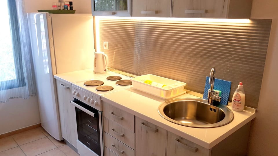 Kitchen with all appliances and kitchenware 