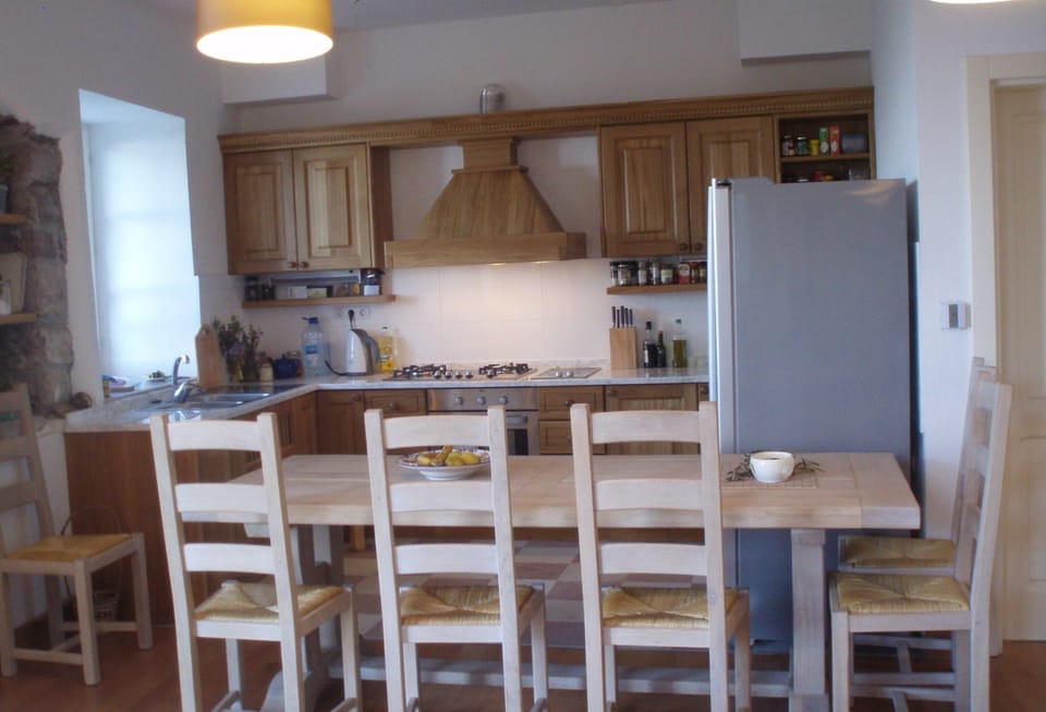 The large oak table that can seat 8 and the bespoke oak kitchen