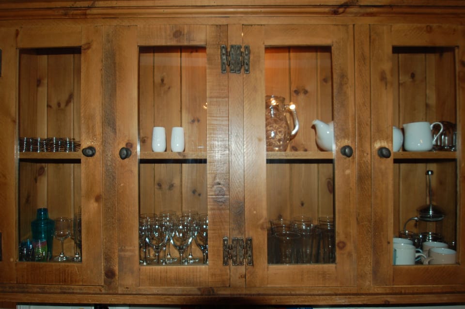 Antique dresser in the kitchen with full complement of glassware and crockery