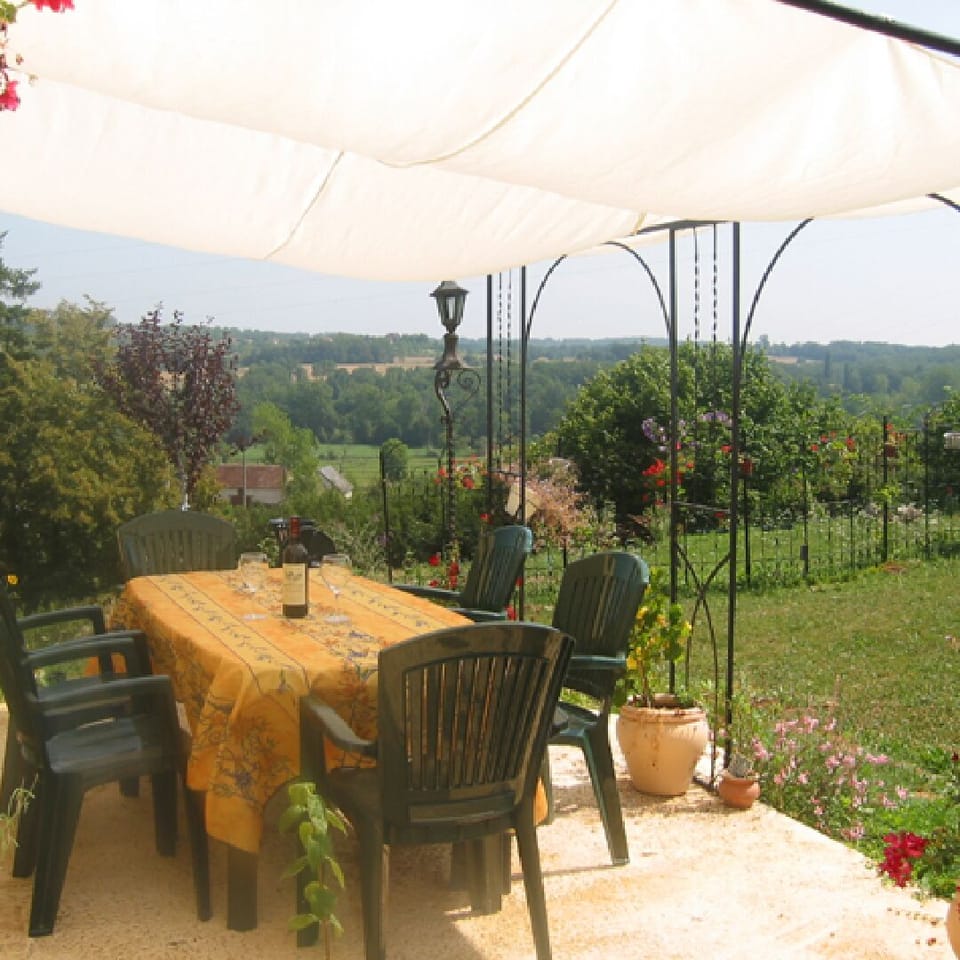 Outdoor dining terrace with valley view.