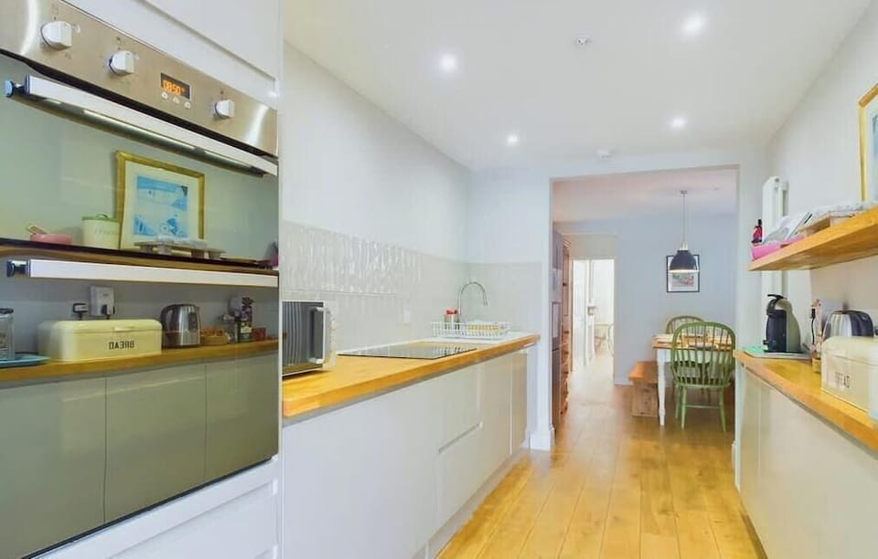 Modern, well-equipped kitchen with quality appliances, perfect for self-catering family holidays.
