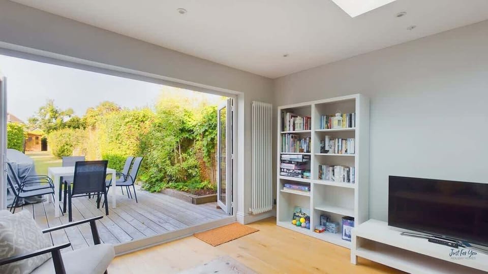 Open-plan living and dining area with bi-fold doors opening to the garden