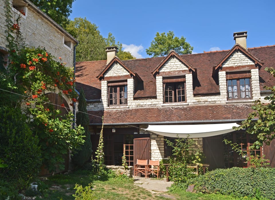 The farmhouse and flowered barn and terrace
