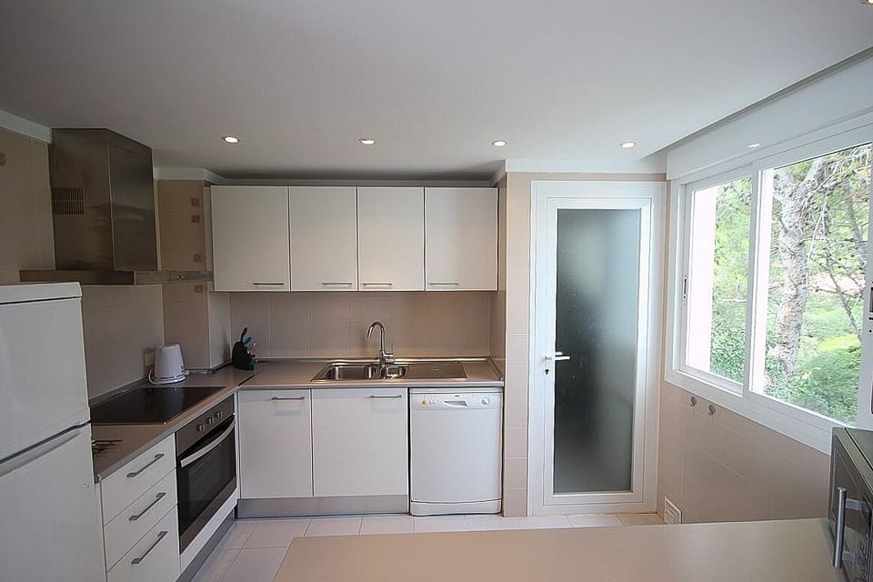 Kitchen. Access to utility room with washing machine, storage and sink