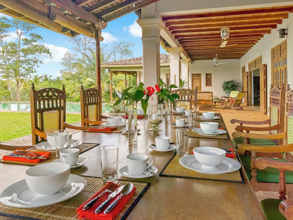 Dining on the veranda. Furniture is all handmade from recycled jakwood.
