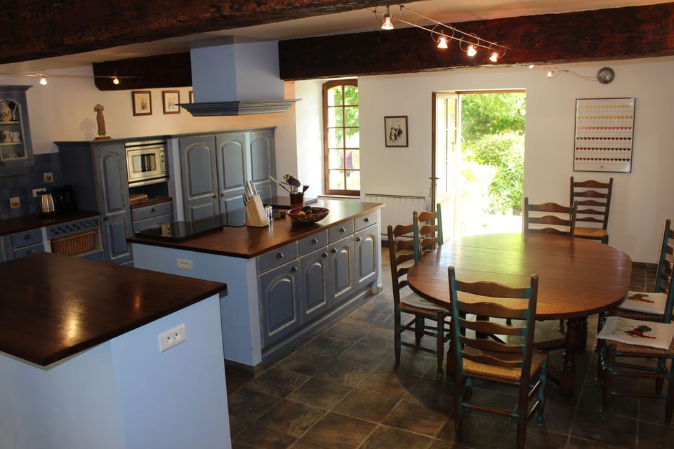 The main kitchen leads to the pool and has ample workspace for all the family!