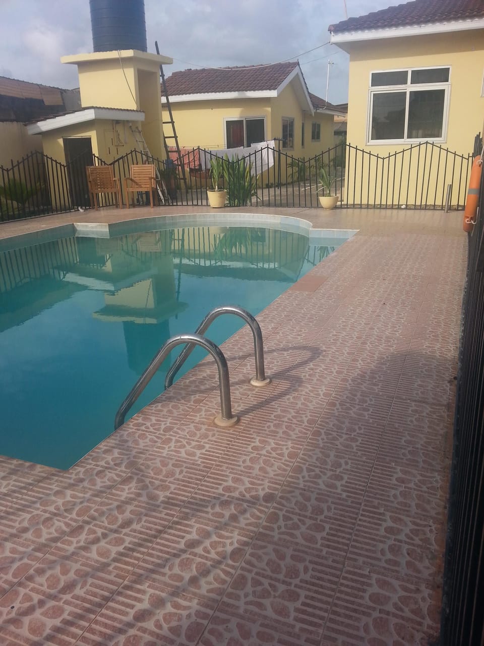 Relaxing swimming pool area with fenced wall