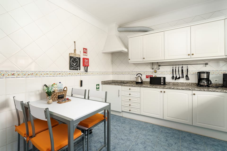 Fully equipped & spacious kitchen, bright window to front yard with fruit tree.