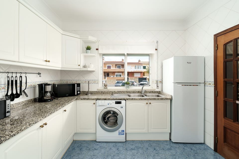 Fully equipped & spacious kitchen, bright window to front yard with fruit tree.