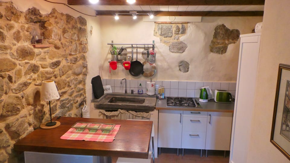 Kitchen with a unique stone sink.